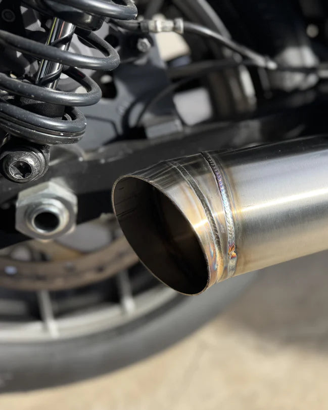 Close up of slip-on muffler exhaust system for a Harley Davidson Nightster, made of stainless steel, installed on a motorcycle, photo 3 of 5