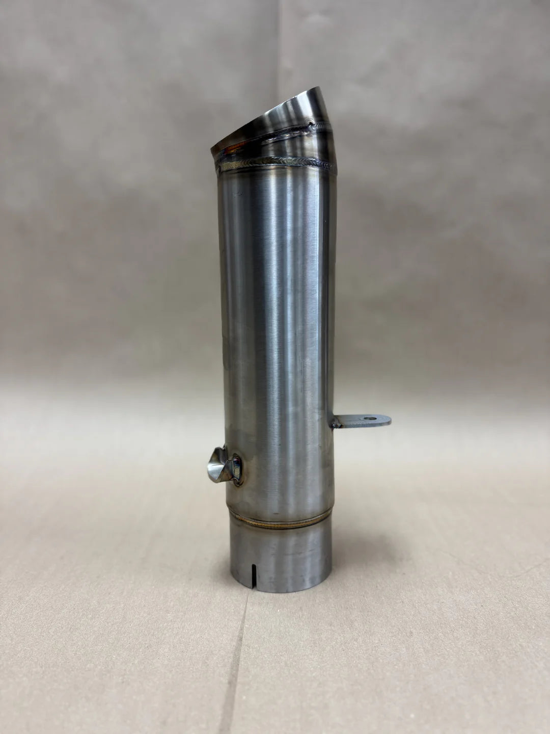 Slip-on muffler exhaust system for a Harley Davidson Nightster, made of stainless steel, showing the product from a side angle against a neutral background., photo 5 of 5