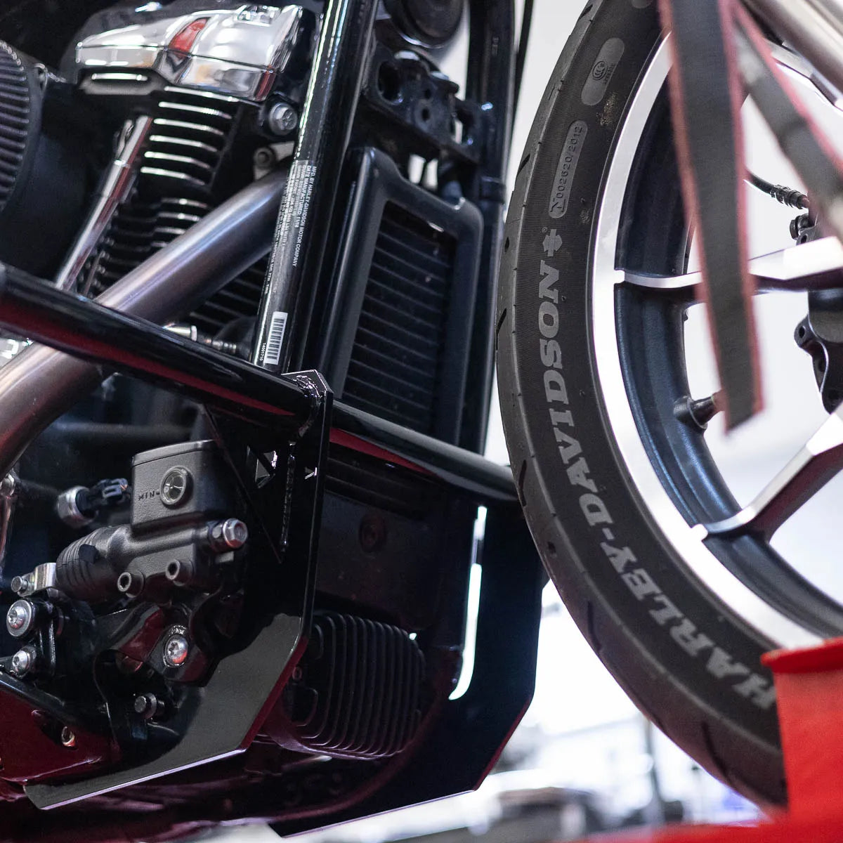A black Softail Front Crash Bar designed for motorcycles, displayed installed on motorcycle., photo 4 of 10