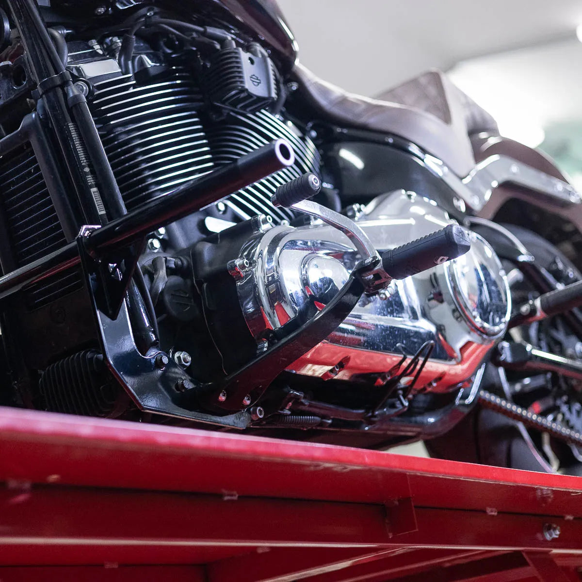 A black Softail Front Crash Bar designed for motorcycles, displayed installed on motorcycle., photo 8 of 10