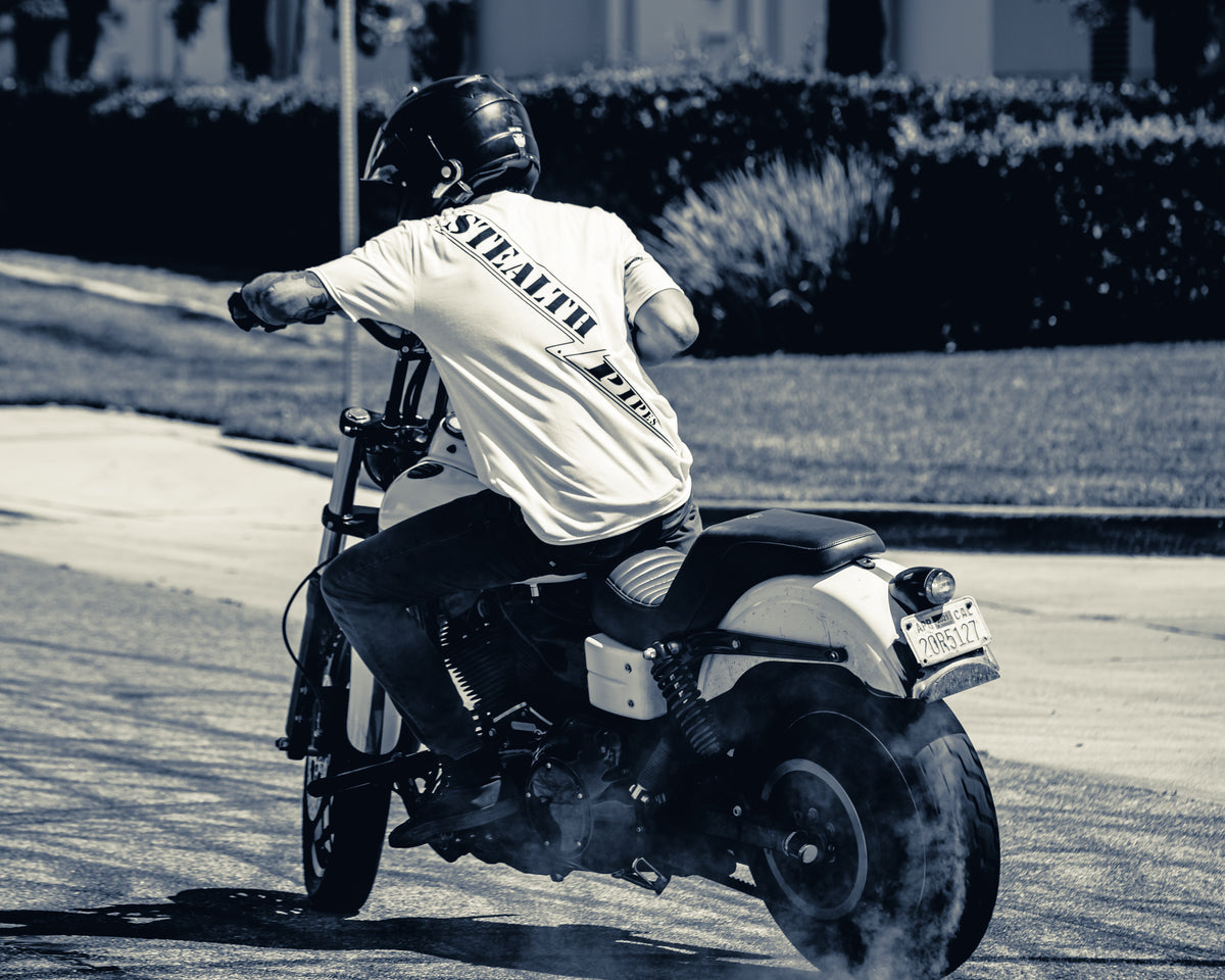 Side view of rider wearing Stealth Rider T-shirt while riding Harley motorcycle, photo 4 of 4